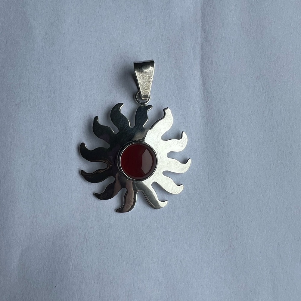 Radiant Silver Sunburst Pendant with Rust Stone Accent